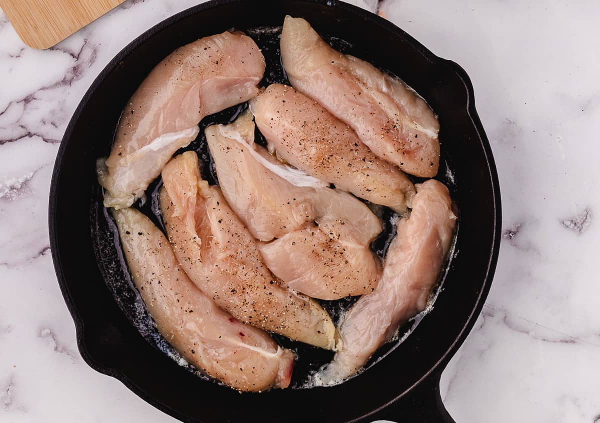 place the raw chicken strips in the pan