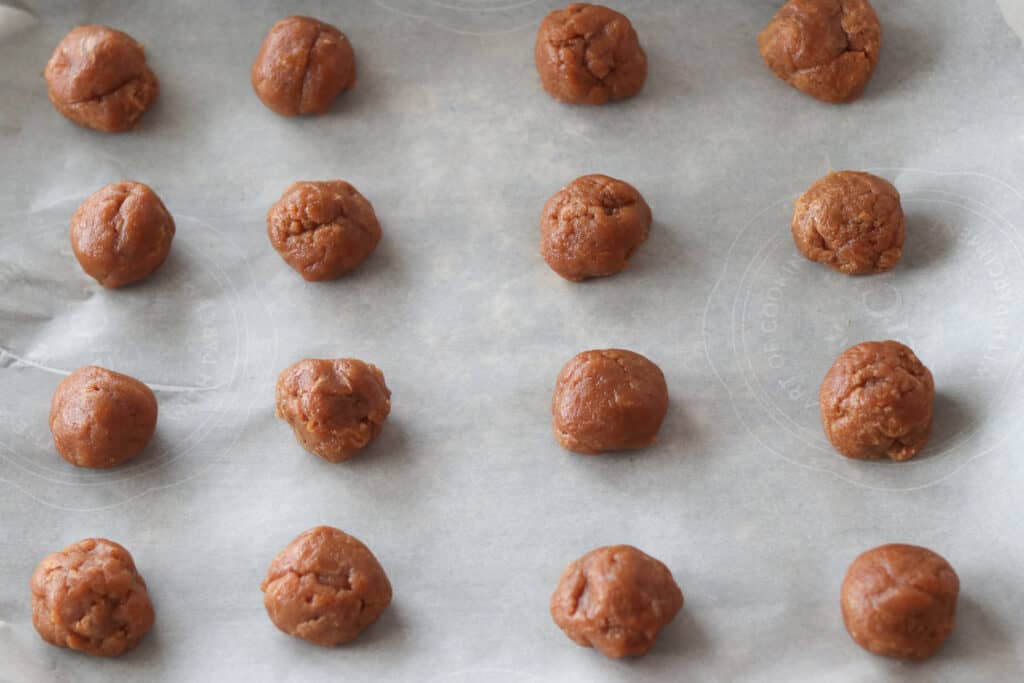 peanut butter gluten free cookie recipe rolled into balls on a pan