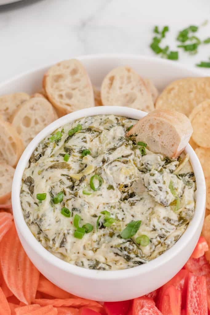 spinach artichoke dip recipes like this pressure cooker version served with bread and vegetables
