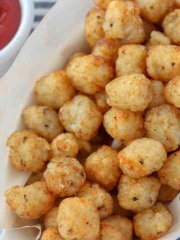 air fryer tater tots in a bowl with ketchup