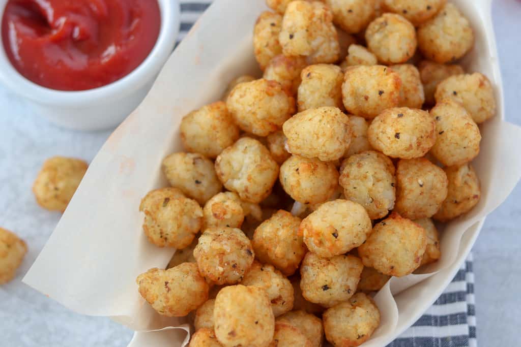air fryer frozen tater tots in a bowl with ketchup
