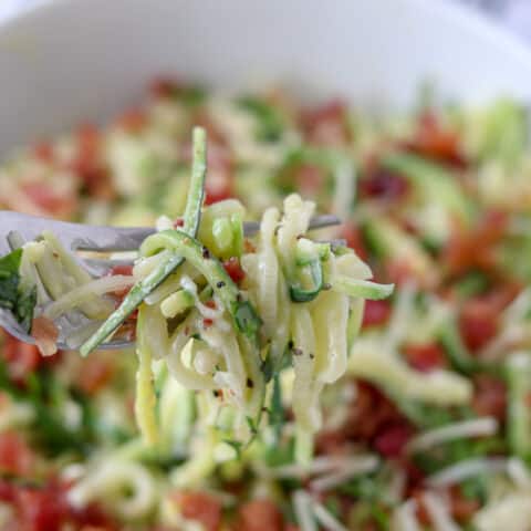 keto pasta carbonara in a bowl with a bite on a fork