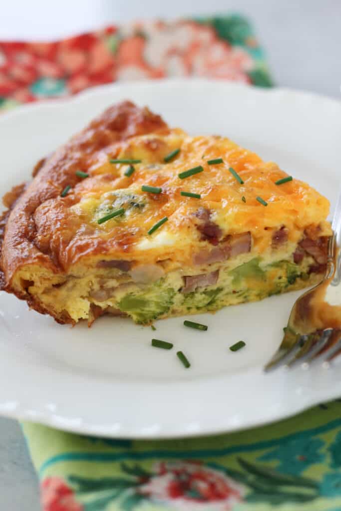 a crustless quiche with broccoli ham and cheese on a plate with no crust
