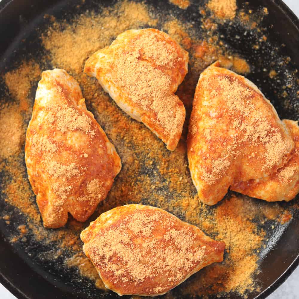 adding seasoning to easy salsa chicken