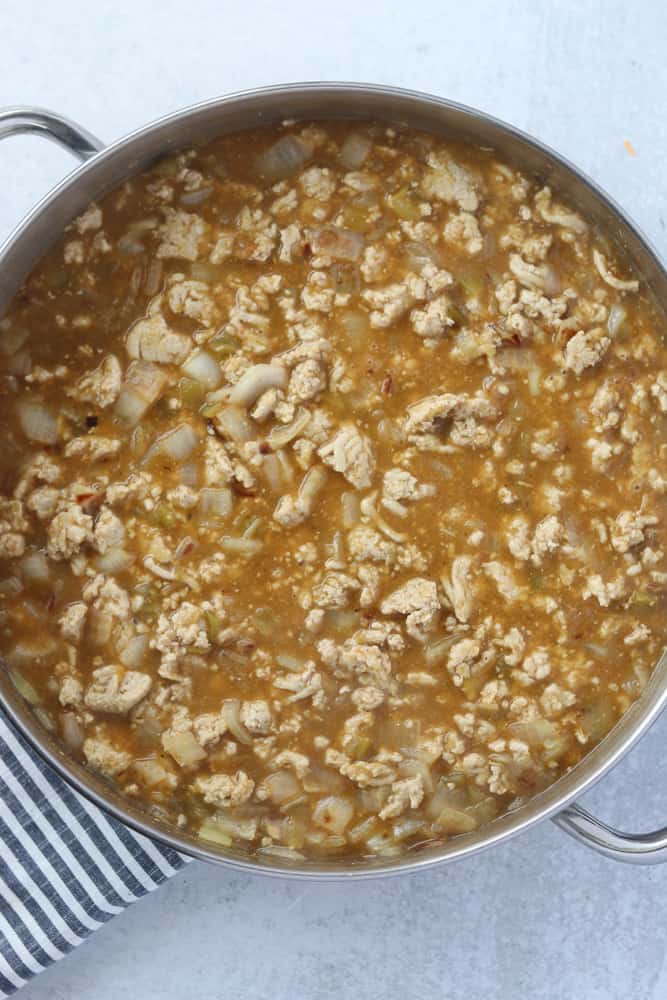 adding the ingredients for keto white chicken chili