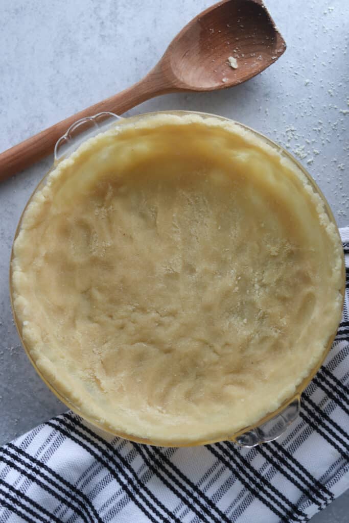 a photo of the low carb pie crust before baking on a gray background