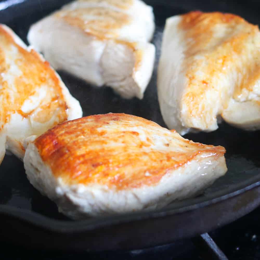 searing the meat for salsa baked chicken