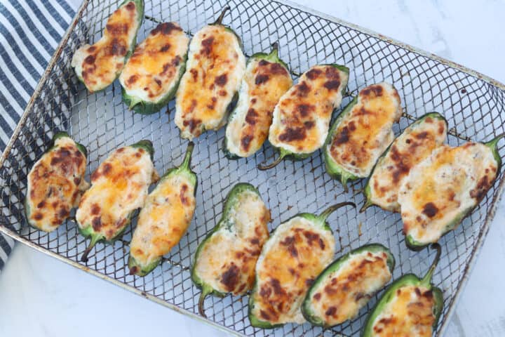 air fryer jalapeno poppers on the baking pan after cooking