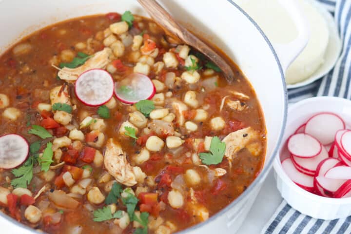 chicken pozole recipe in a pot with garnishes