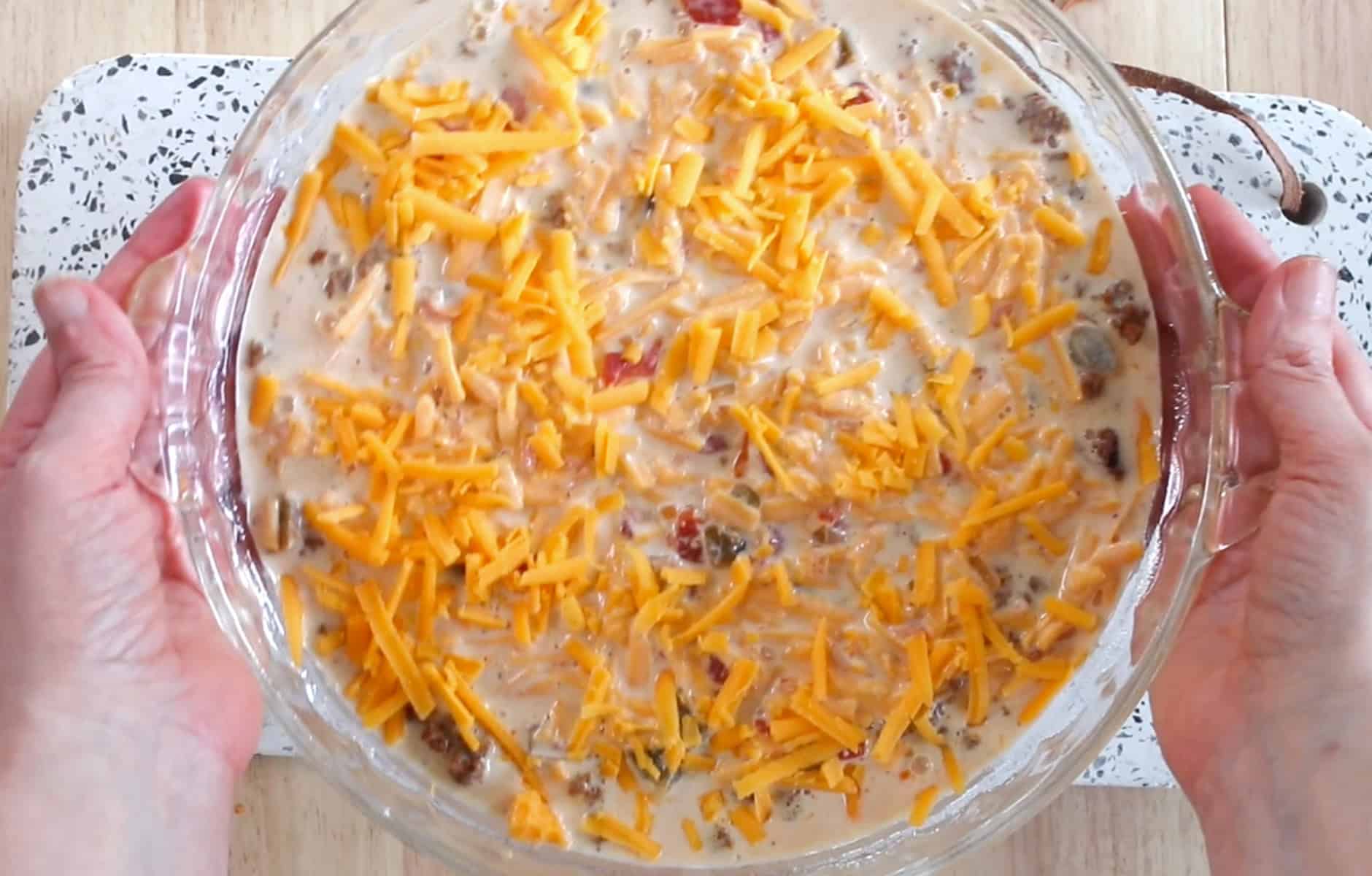 pouring taco pie filling into a pan