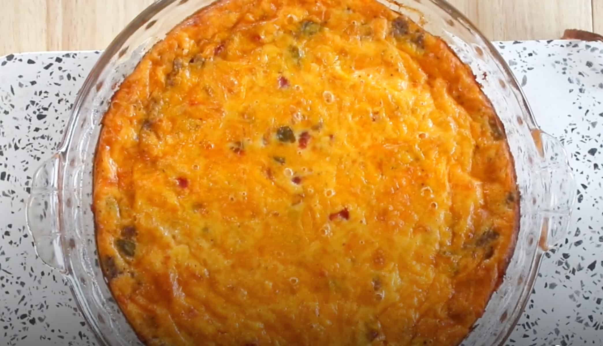 pulling the baked taco pie out of the oven and letting it rest