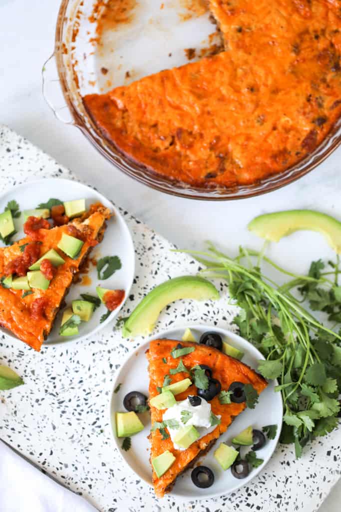 keto taco pie crustless pie in a pie pan with slices on the side