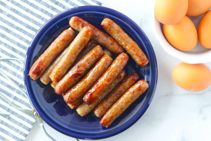 link sausage in air fryer on a plate with eggs