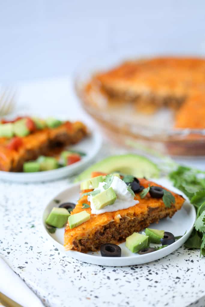 sliced low carb taco pie at an angle on a cutting board