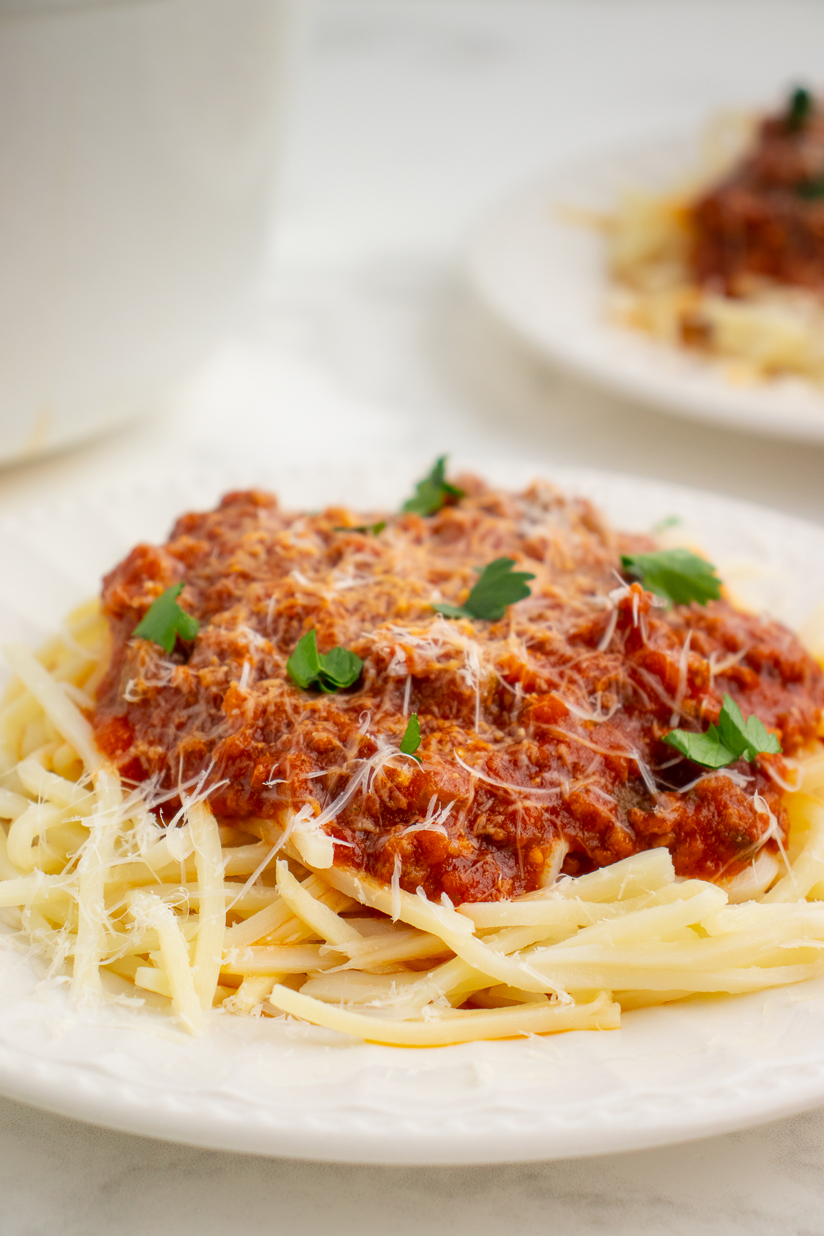 low carb meat sauce on a bed of low carb pasta topped with shredded parmesan cheese