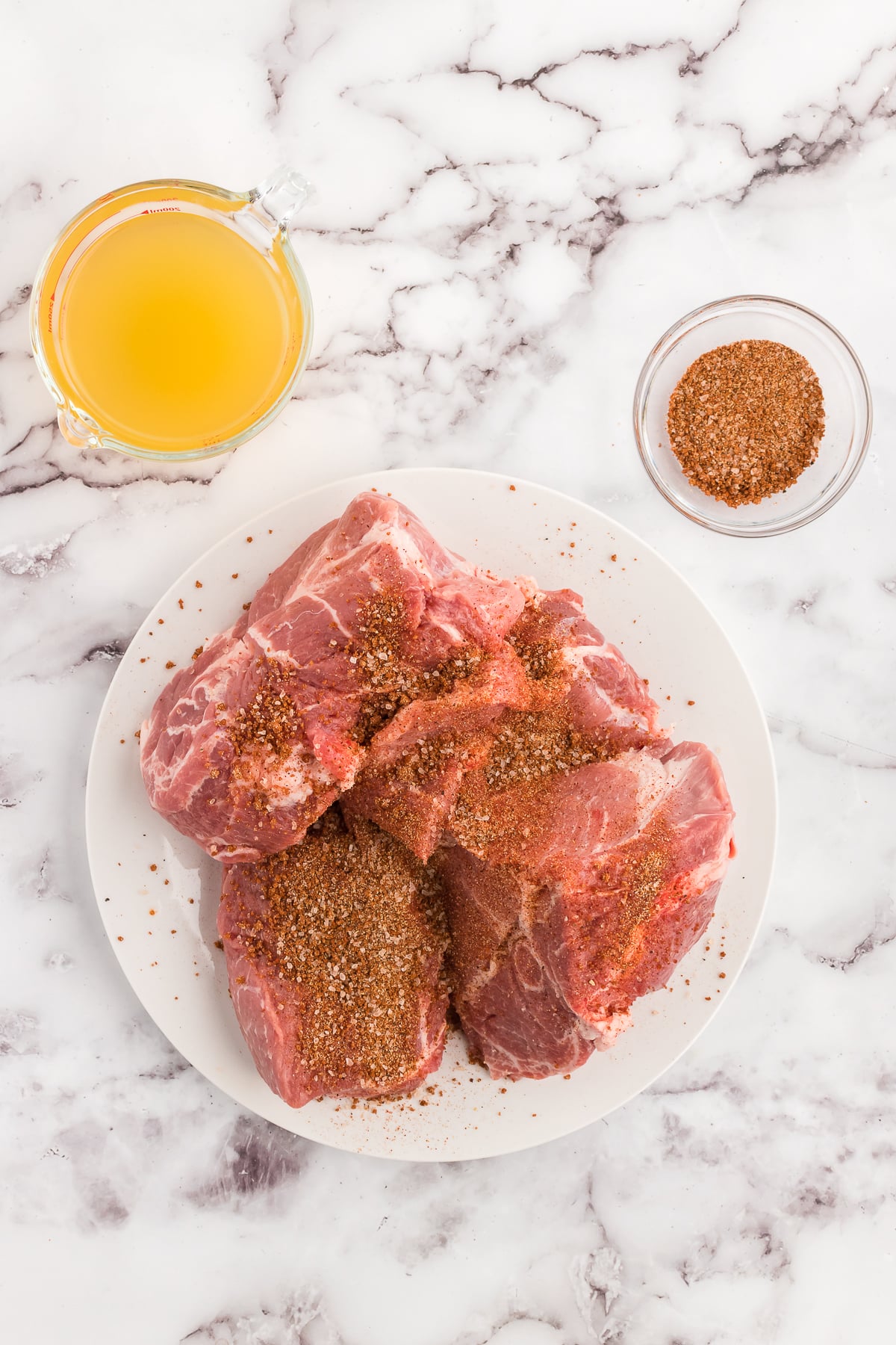 cutting the pork roast into fours and seasoning