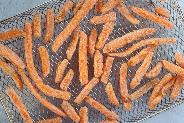 air fryer frozen sweet potato fries on a tray before cooking