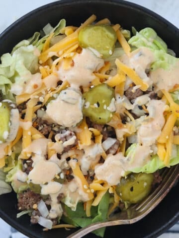 big mac bowl closeup with toppings in a black bowl