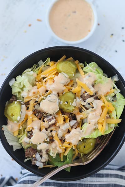 keto big mac sauce drizzled over the top of a cheeseburger salad