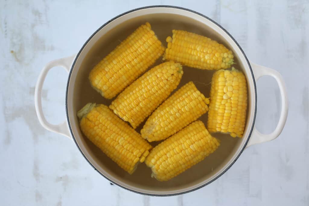 doing a corn on the cob boil can be with just water. Showing corn about to get cooked in a pot.
