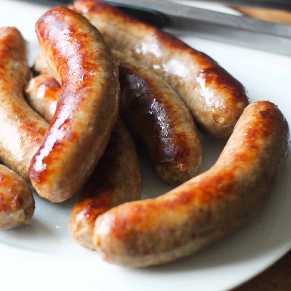 how to cook bratwurst with a plate of cooked brats golden brown