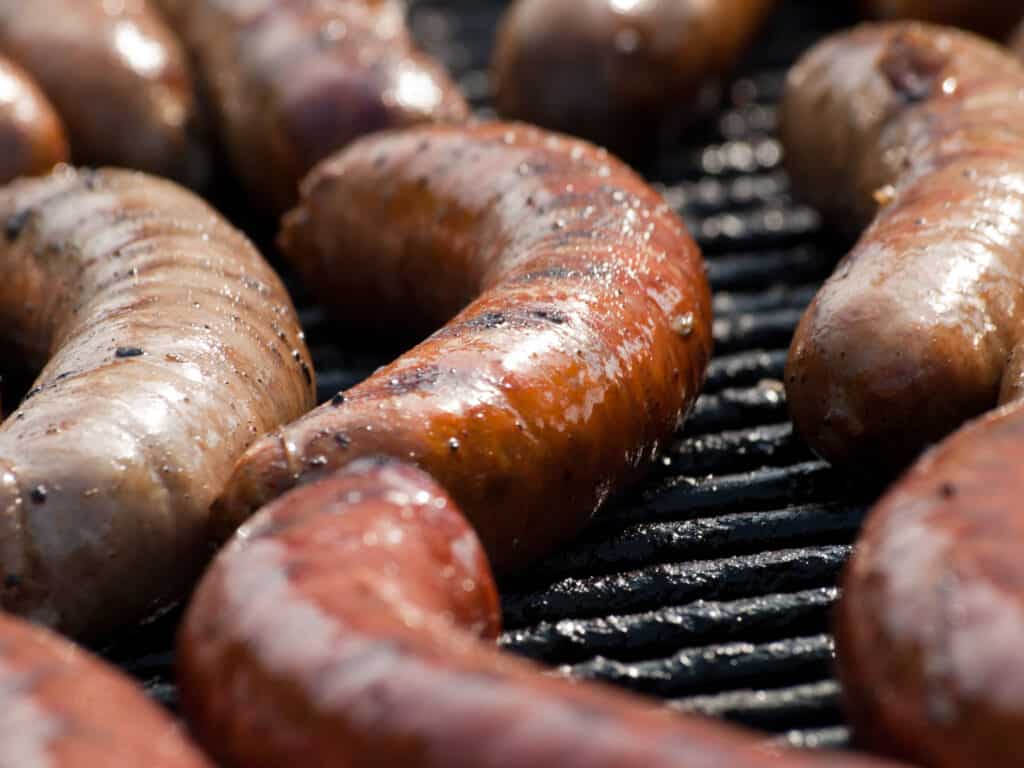 how to grill brats photo on them cooking on a bbq