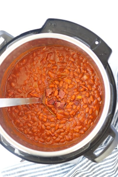 instant pot baked beans in a pressure cooker with spoon