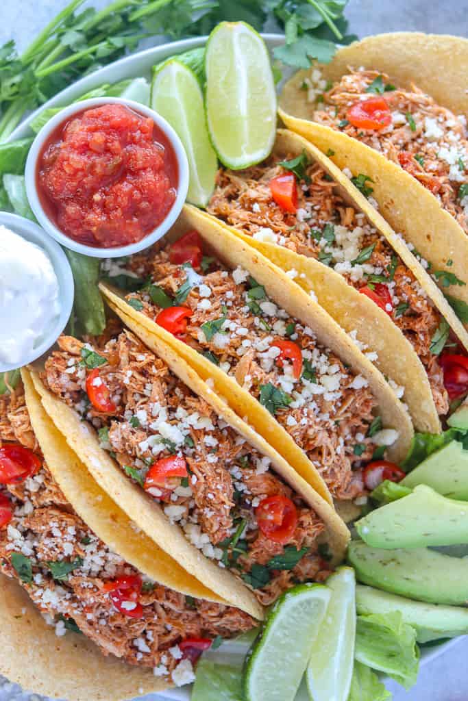 instant pot chicken tacos with garnishes on a platter