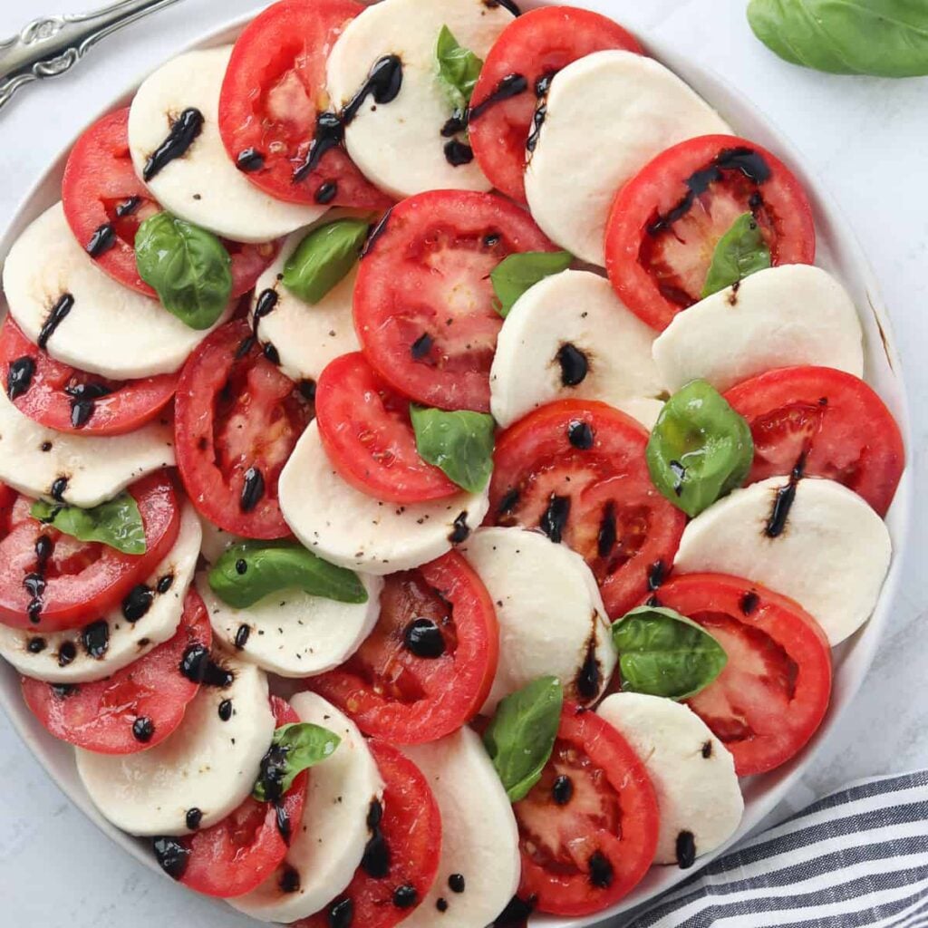 recipe for caprese salad with the final dish on a platter