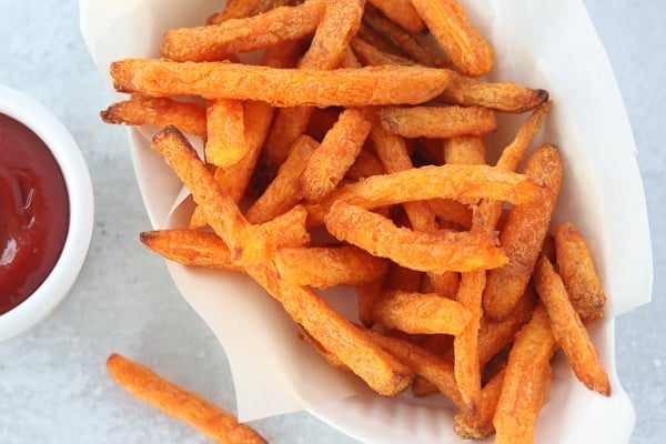 sweet potato fries air fryer recipe in a bowl with a side of ketchup