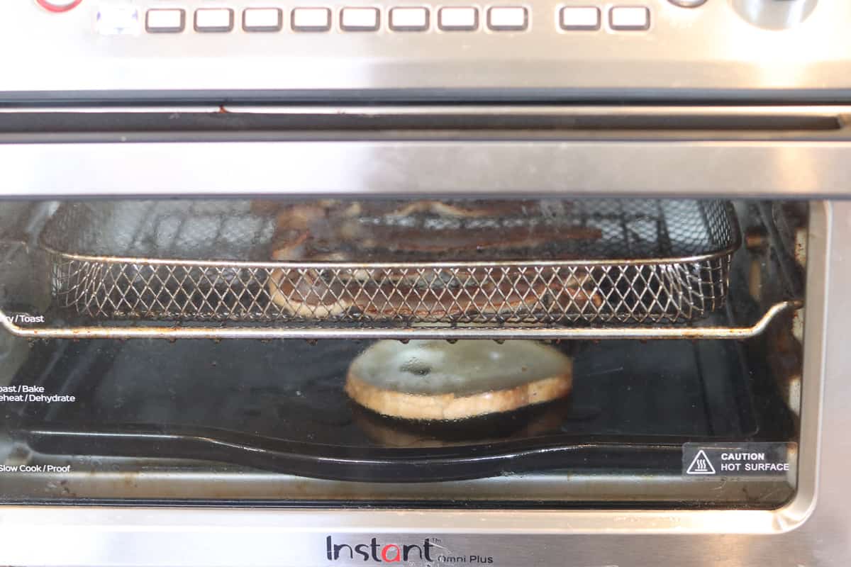 preventing air fryer bacon smoke with a piece of bread in the bottom on the unit