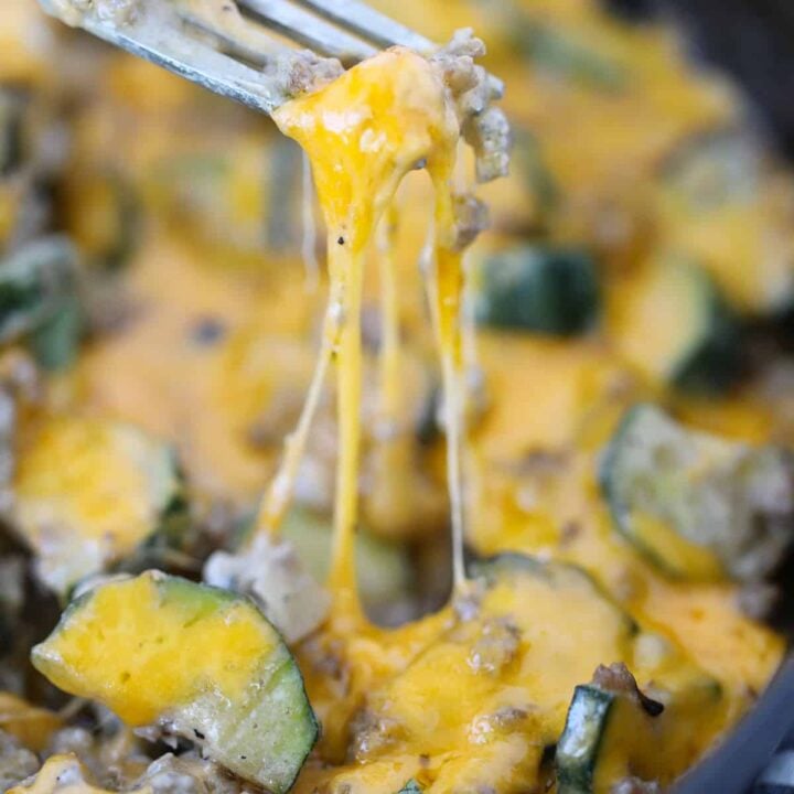 cheesy beef and zucchini casserole close up view of cheese pull