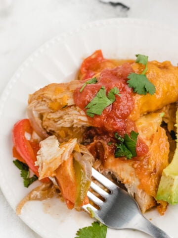 chicken fajita bake on a plate with a bite out of it