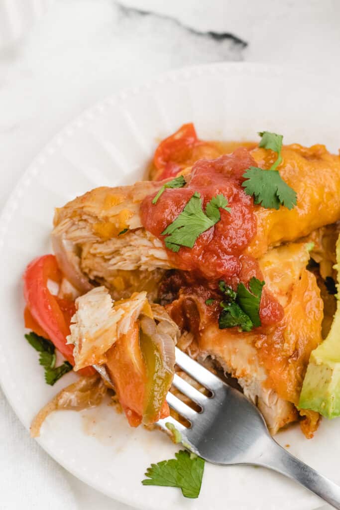 chicken fajita bake on a plate with a bite out of it