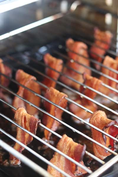 cooking bacon in an air fryer for a crowd is easy by draping it over the omni plus rack or by twisting the pieces