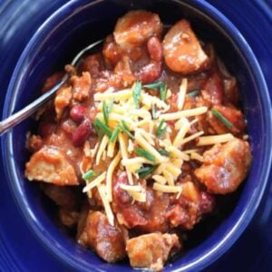 kielbasa chili in a blue bowl square image looking down