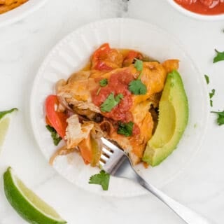 fajita bake on a white plate with garnishes