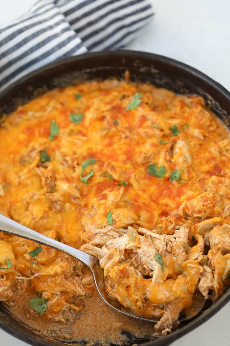 keto chicken enchilada casserole after cooking on a white back ground in a cast iron pan