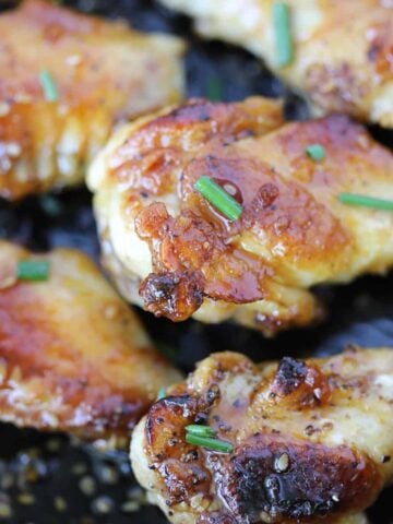 pan fried chicken wings close up photo with sauce