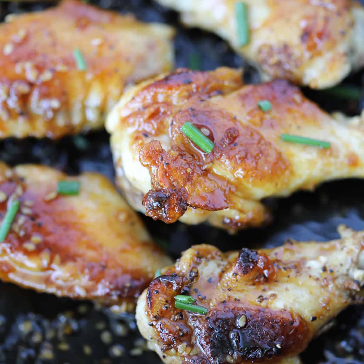 pan fried chicken wings close up photo with sauce