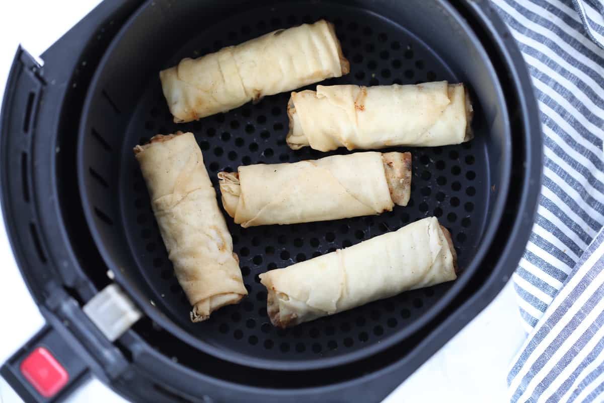 air fryer egg rolls frozen in an air fryer basket