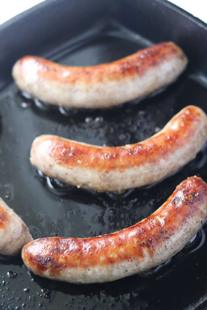 searing the brats in a skillet before adding to the slow cooker