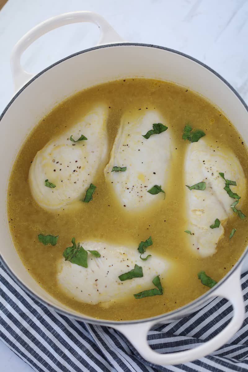 how long to boil chicken depends on if it's fresh or frozen, cooked chicken on the stove in a pot with herbs