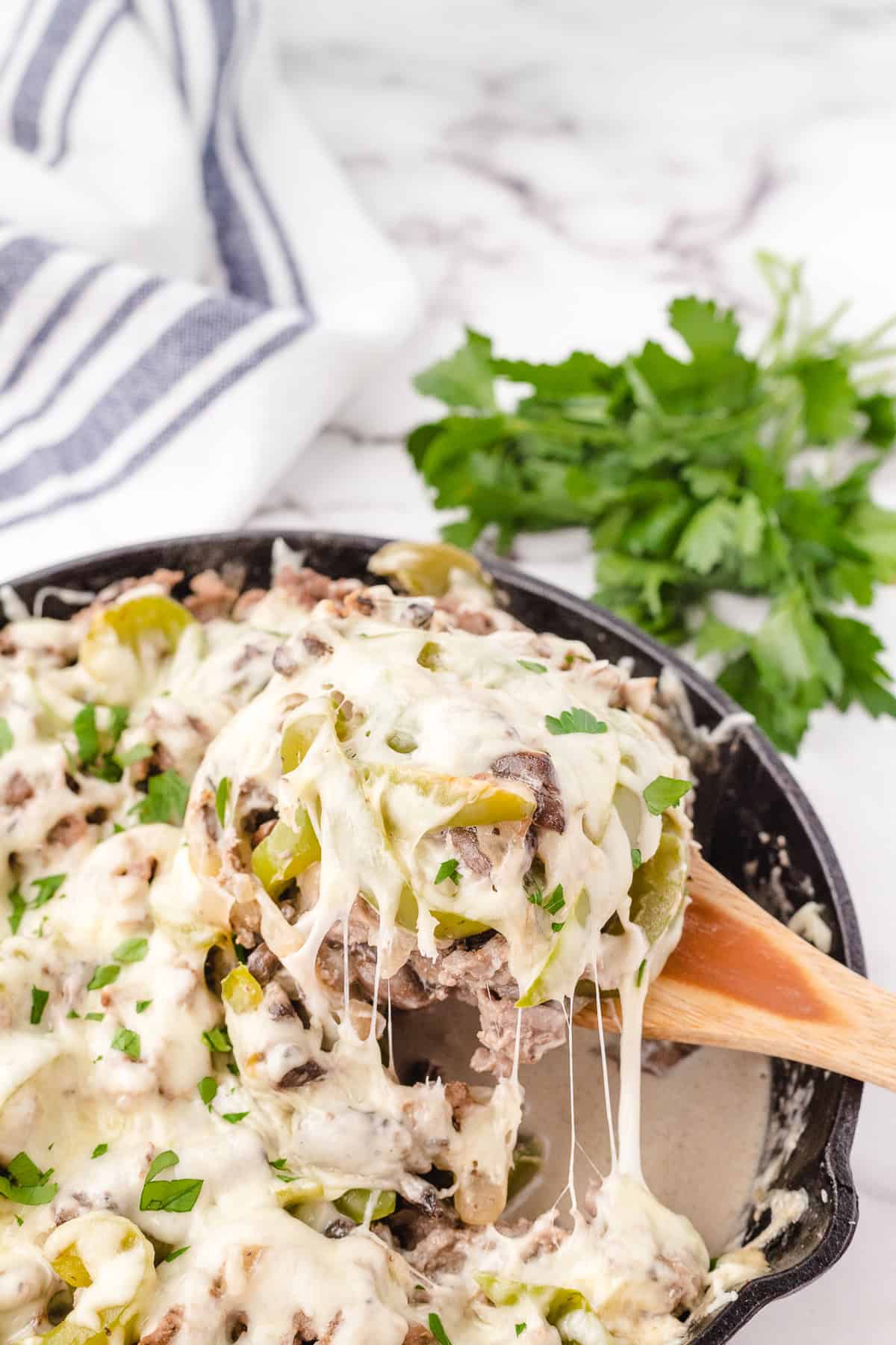 philly cheese steak after cooking on a spoon with cheese dripping off