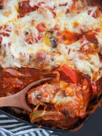baked italian sausage with a spoonful of casserole