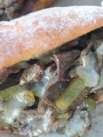 the best philly cheesesteak recipe closeup image with hot melted cheese