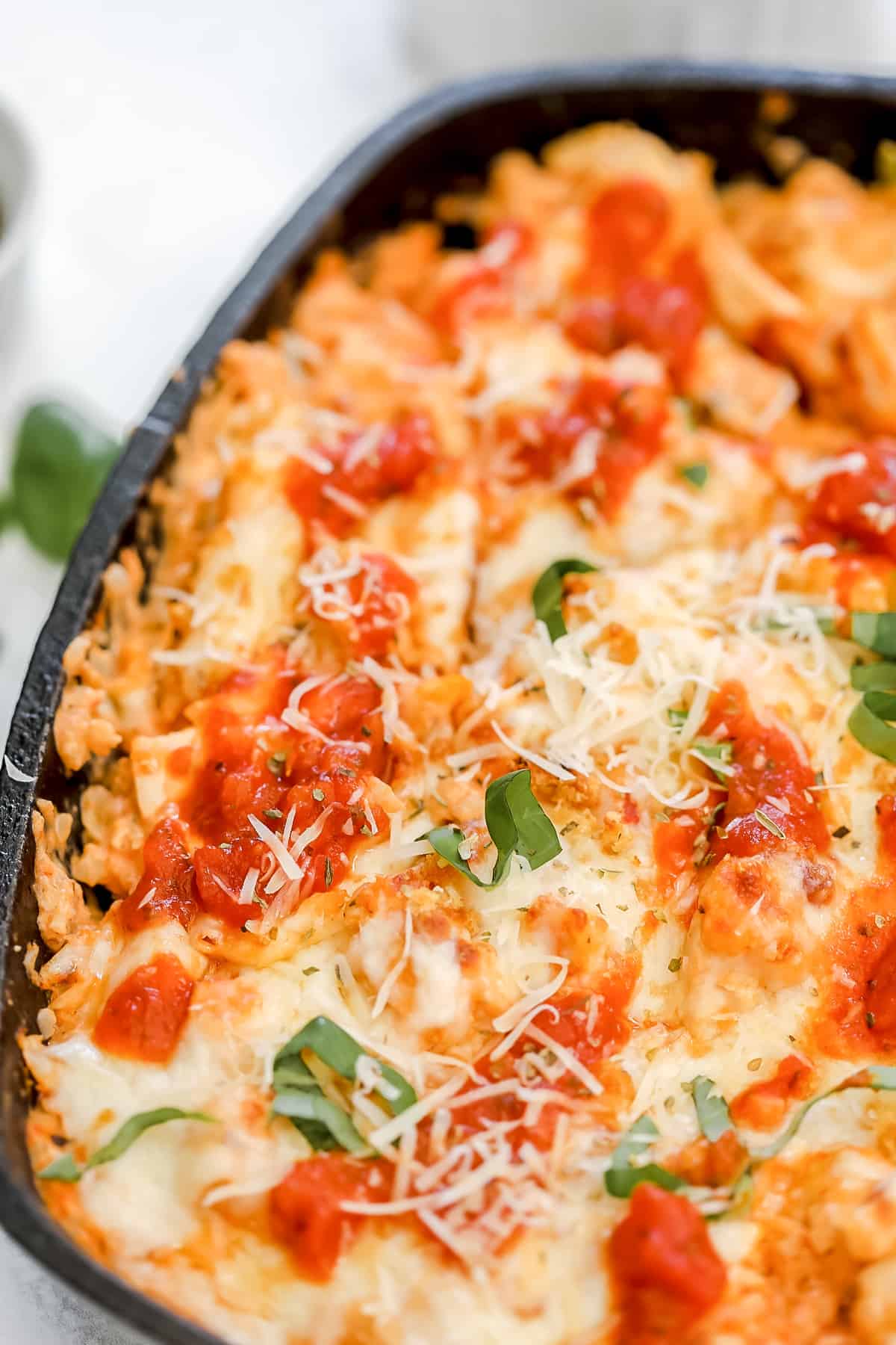 keto chicken parmesan casserole without pasta in a cast iron skillet after getting baked
