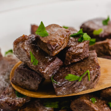 air fryer steak tips on a wooden spoon