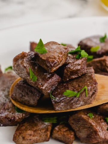 air fryer steak tips on a wooden spoon