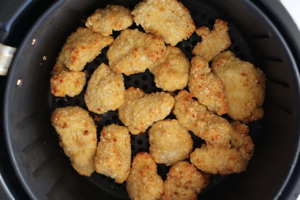 air fryer chicken nuggets frozen and now cooked in the basket before serving